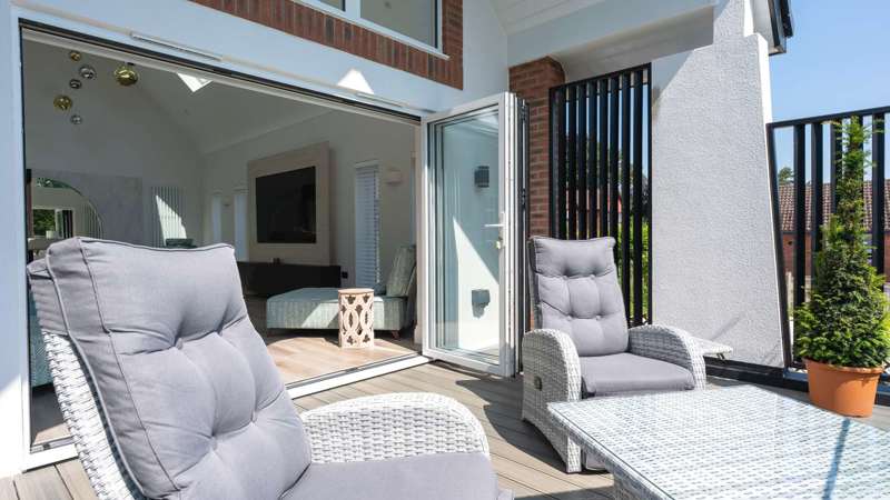 Bifolds opening on to the balcony.